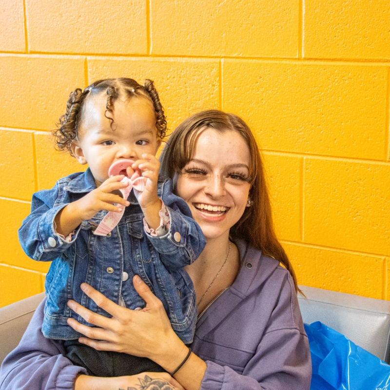 Woman with her child at Santa Day, a Children Youth and Family event.