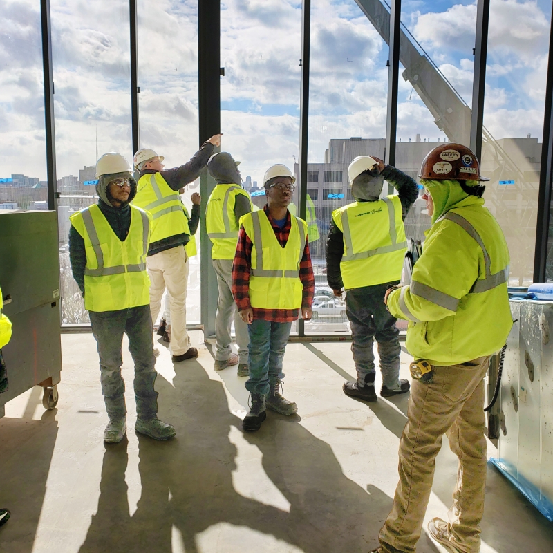 Construction workers talking on a building